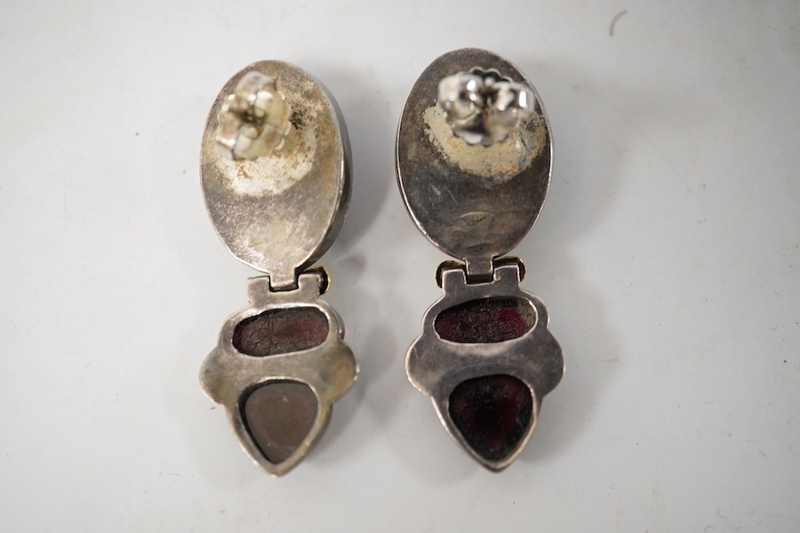 A pair of modern yellow and white metal mounted three stone oval cabochon garnet set drop earrings, by Elaine Coyne, signed, 51mm, gross weight 28.2 grams. Condition - fair